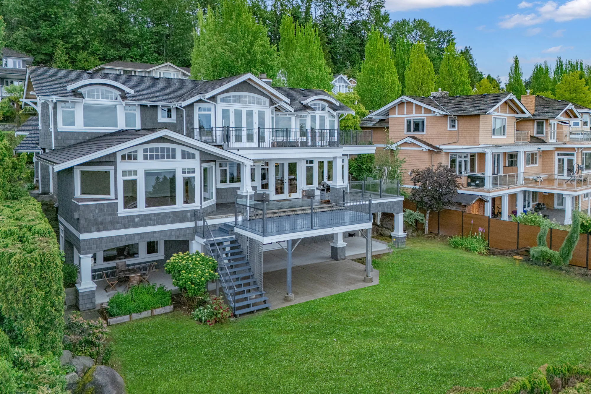 The house and garden from a lower angle, the deck and the stair down from the balcony