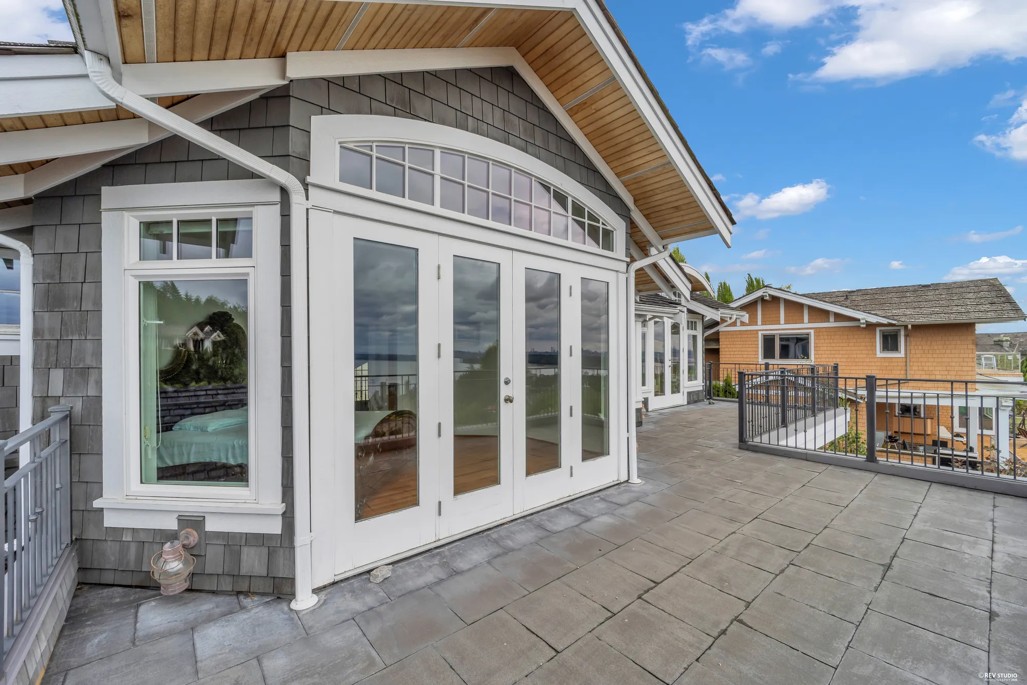 The upper balcony outside the bedrooms, glazed doors on one side and the rail on the other