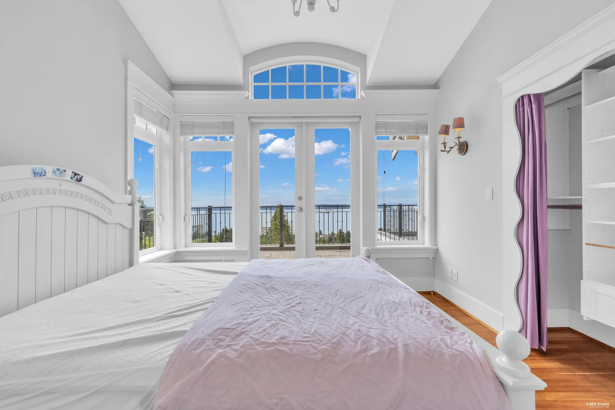 The same bedroom from the door, the window bay filling the far wall