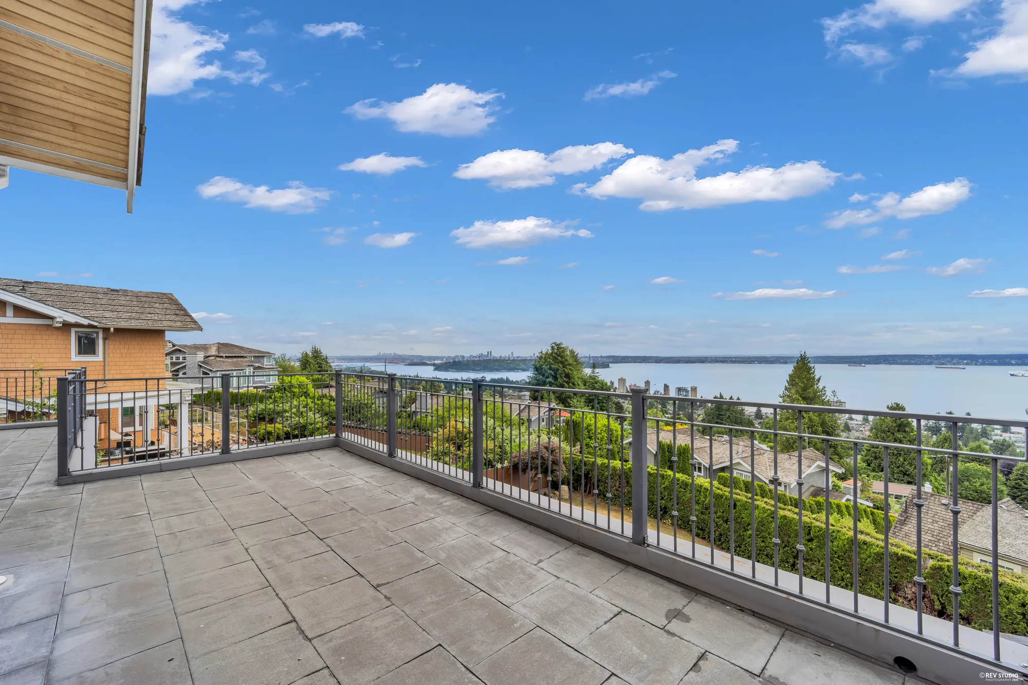 Looking down from the upper balcony over the deck and the lawn to the water