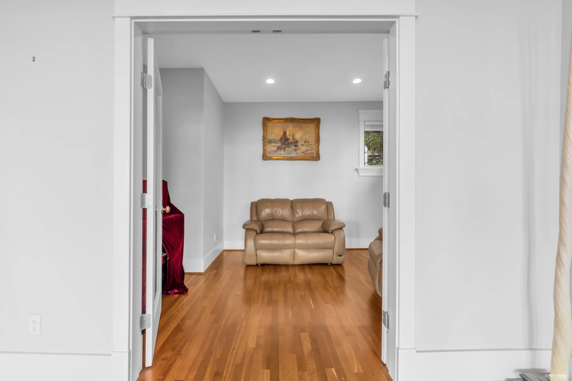 The main-floor hall running past a doorway into a further room