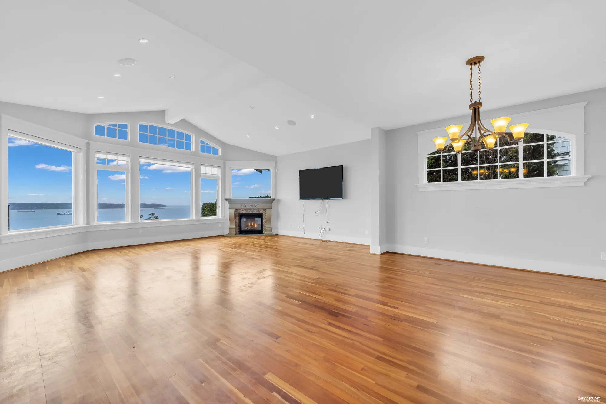 The family room end with windows on two sides and the balcony doors between them
