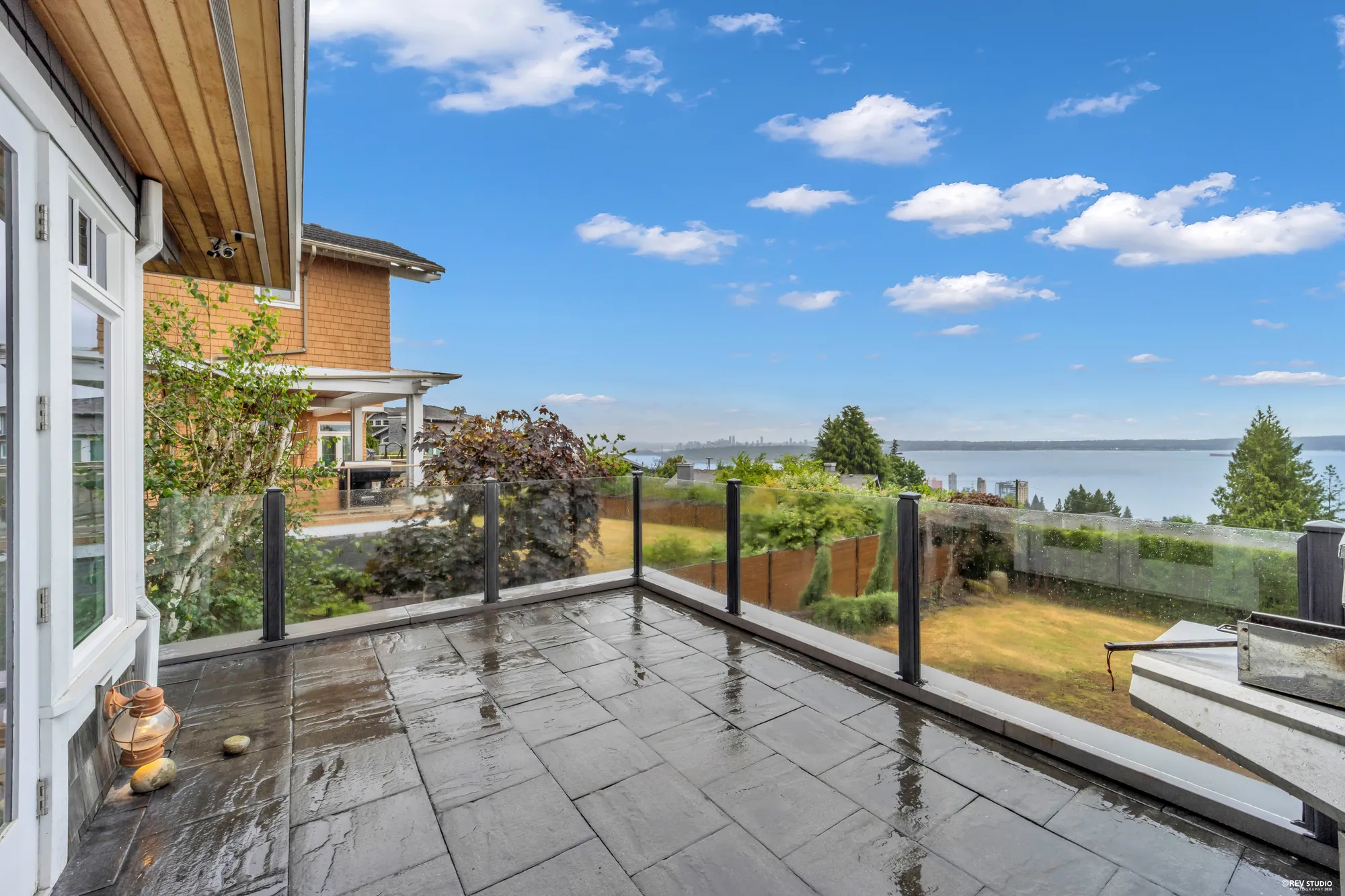 The loggia from the garden end, the house glazing on the left and the hedge on the right