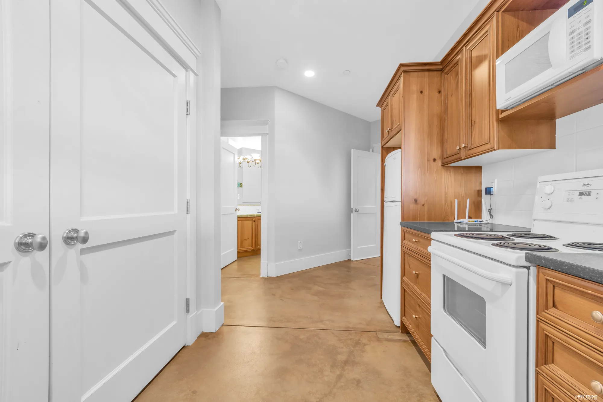The lower kitchen from the hall, the range and the counter run beside the doorway