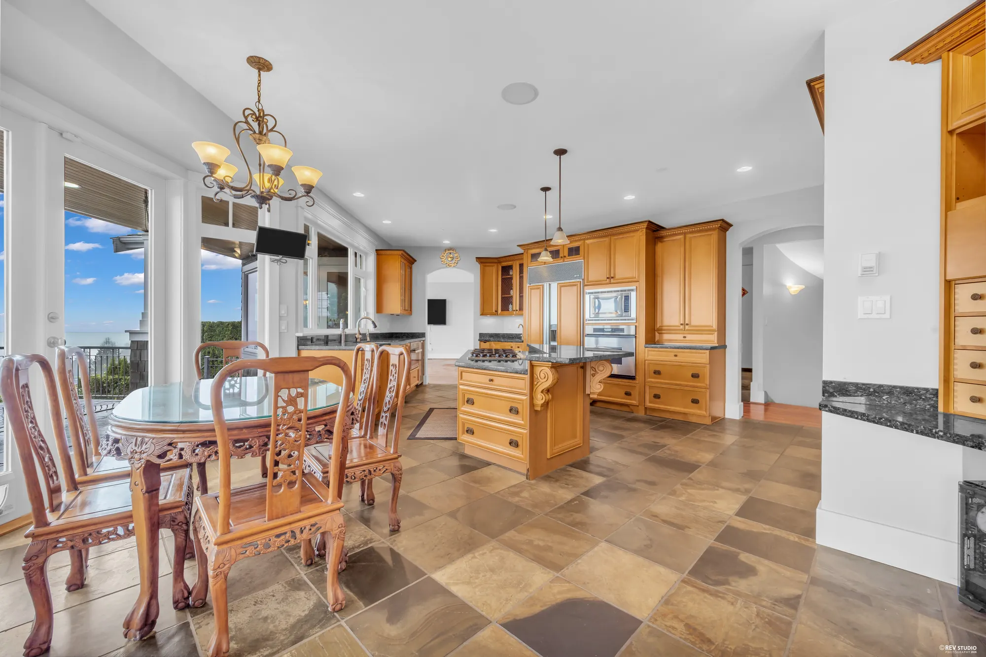Kitchen, nook and the slate floor in one wide frame with the windows along the view side
