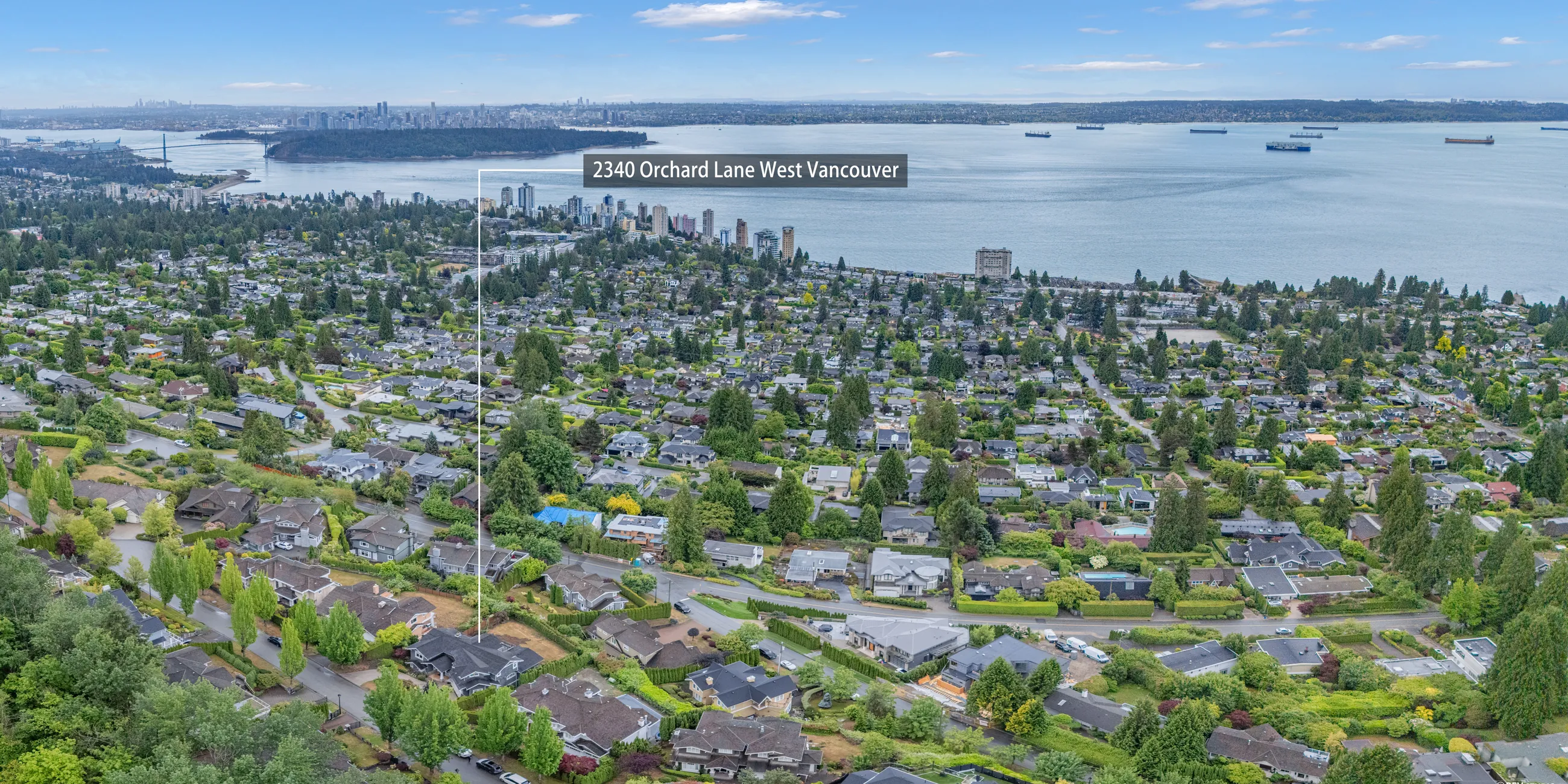 Aerial panorama along the West Vancouver shore with freighters at anchor and the property marked above Dundarave