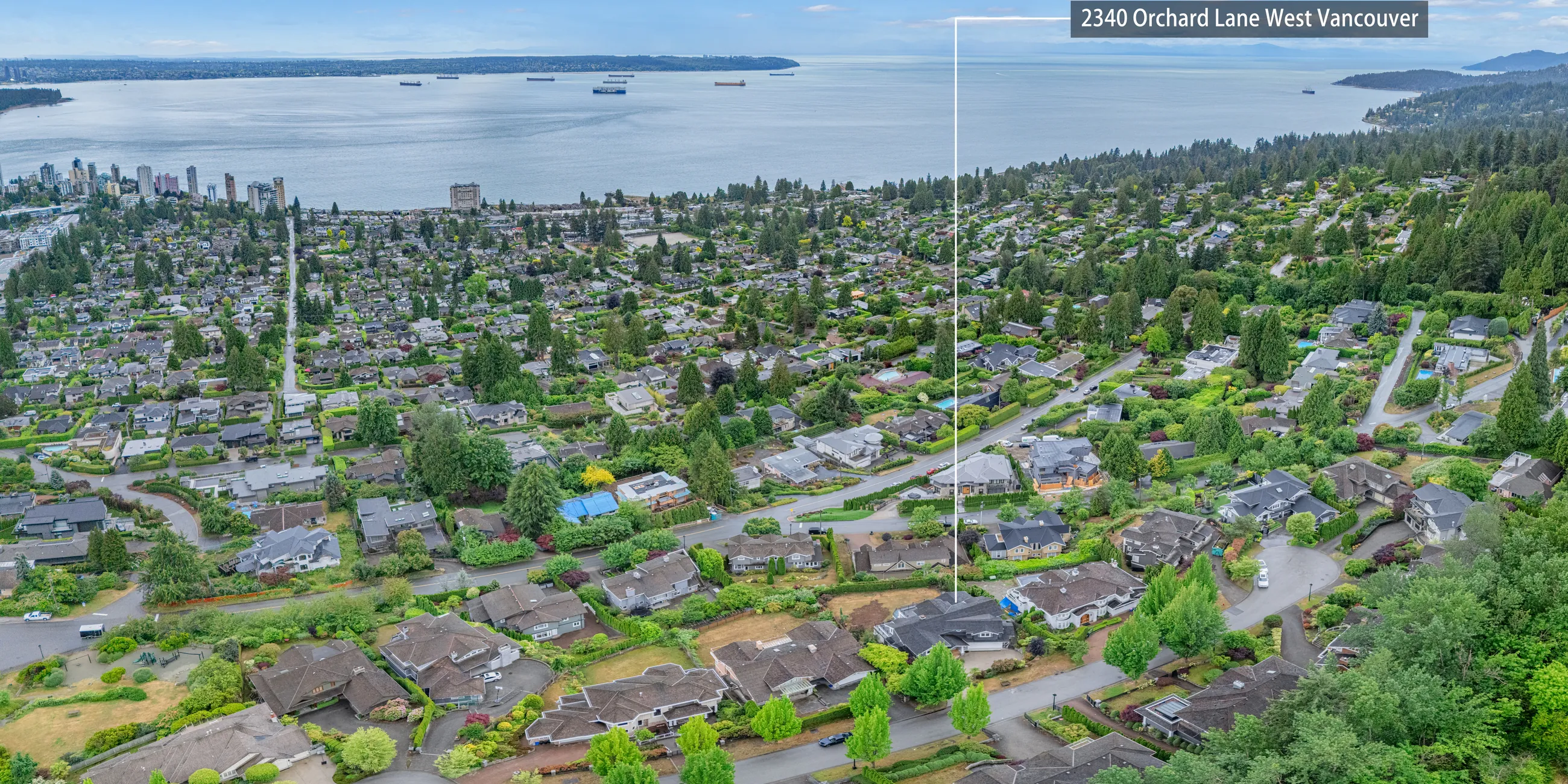 Aerial panorama from over the roof: downtown Vancouver, Stanley Park and the Lions Gate Bridge on the left, out to the Gulf of Georgia on the right, with the property marked