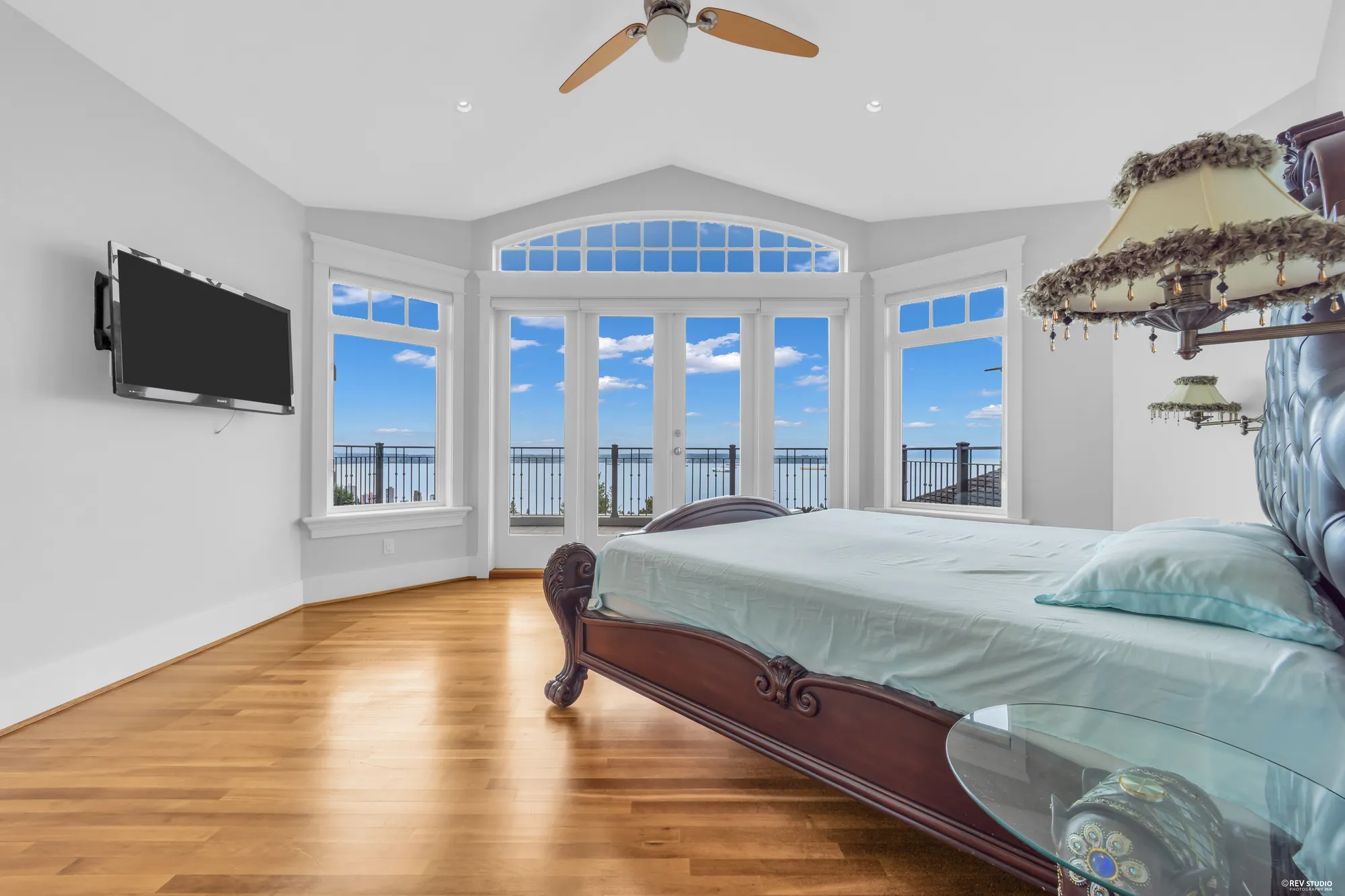 The primary bedroom with the television wall on the left and the window bay on the right