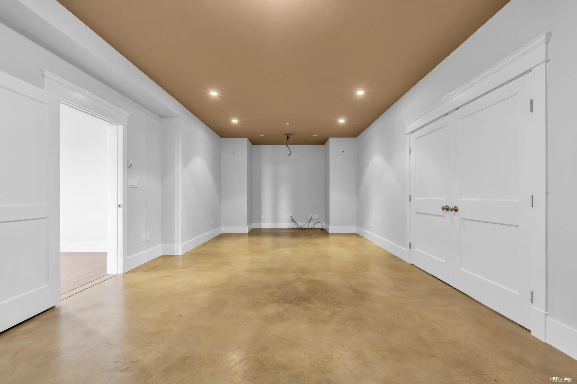 The theatre room from the doorway, doors at both ends and the coffered ceiling above