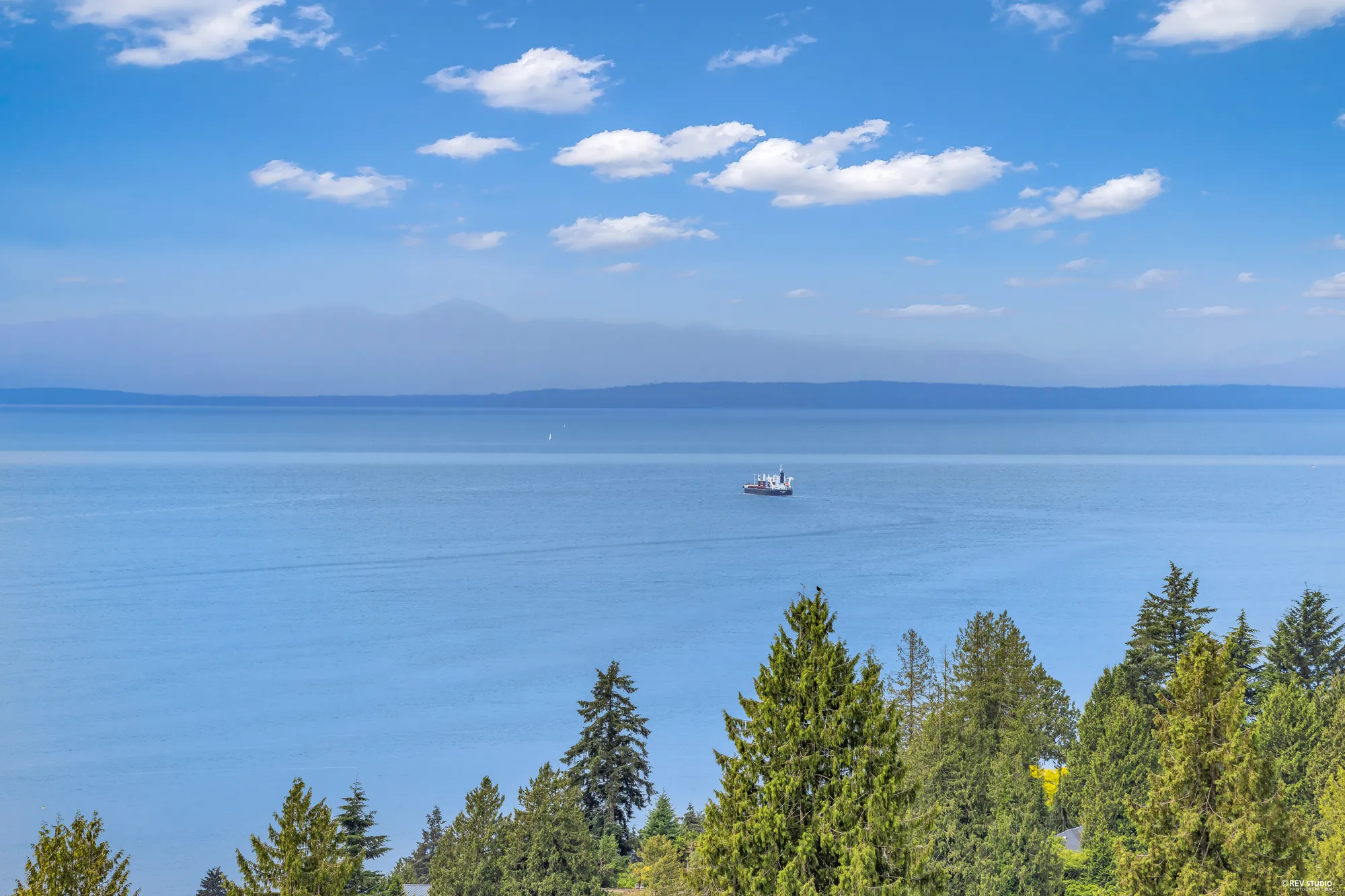 Open water to the south-west, a freighter under way and the far shore low on the horizon